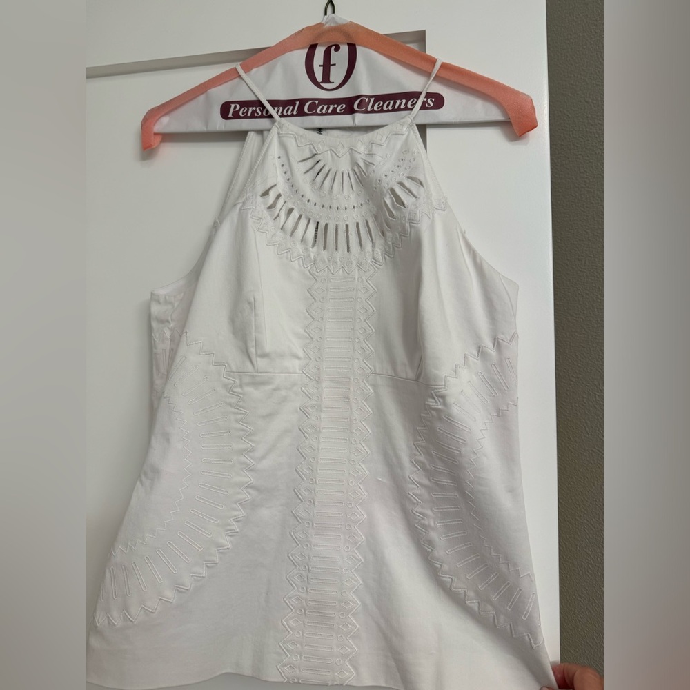 Karen Millen white top with back and side zipper. Excellent condition.